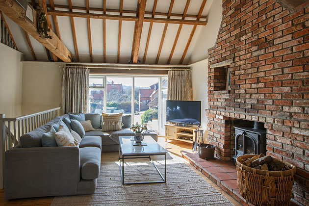 Flintstone Barn Cottage's lounge looking out of the main windows