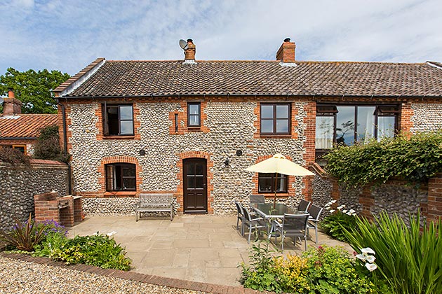 Old Flint Barn Cottage's patio garden and front