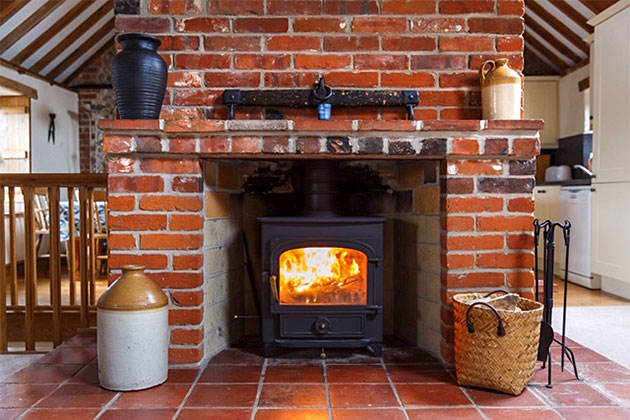 Old Flint Barn Cottage's upstairs fireplace