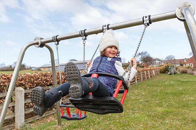 Toddler enjoying a toddler-sized swing