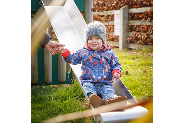 Toddler enjoying the toddler slide